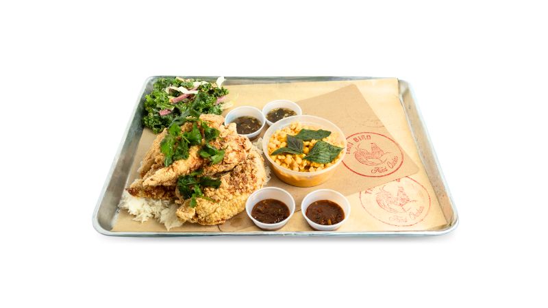 A metal tray with crispy, whole white meat chicken tenders — antibiotic-free and cooked to order.