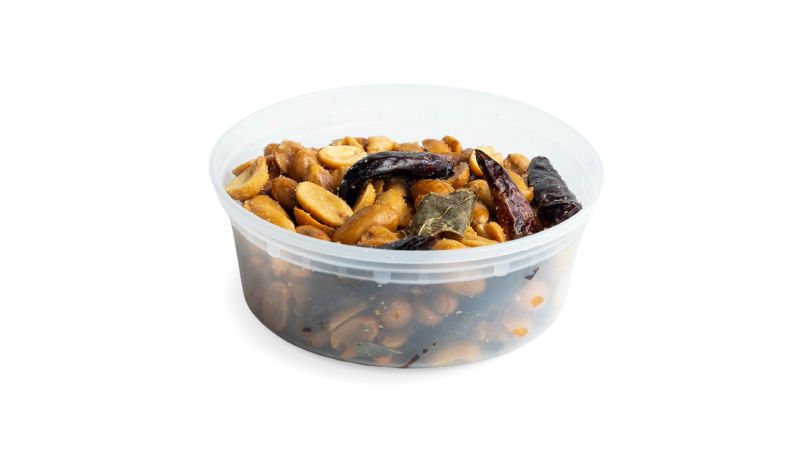 A cup of roasted housemade peanuts tossed with lime leaf, garlic, and crispy roasted chiles.