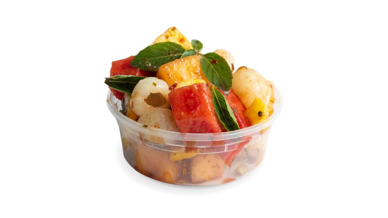 A cup of seasonal fruit tossed with tamarind, ginger, and fresh Thai basil.